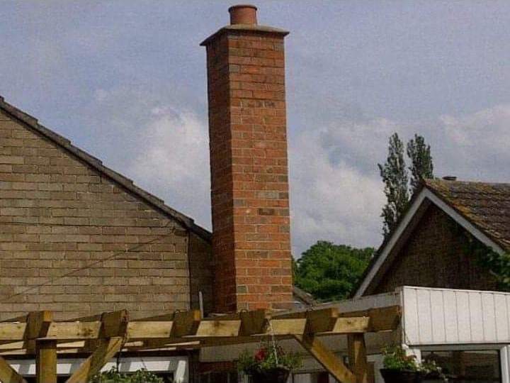 Brick gable apex against slate roof