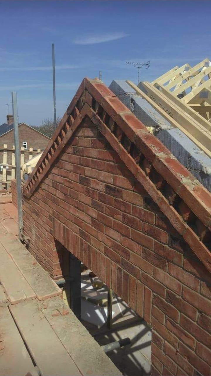 Brick gable end with roof timbers